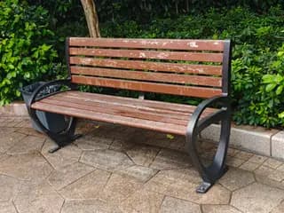 Park chair with cast-iron armrests and a wooden seat